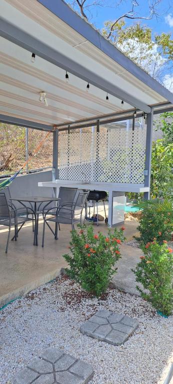a patio with a table and chairs under a pavilion at Cacique Room 2 in Playa Hermosa