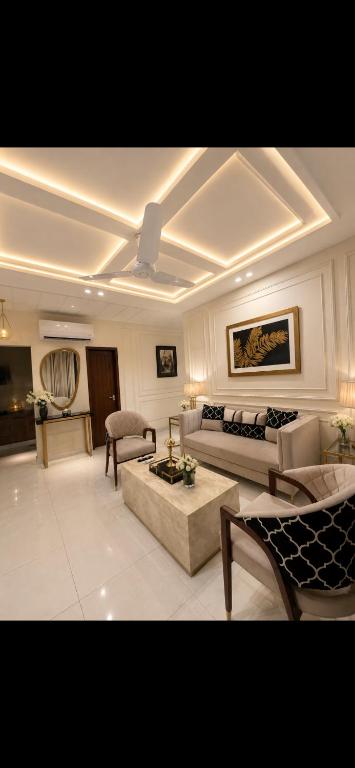 a living room with two couches and a couch at Global properties in Faisalabad