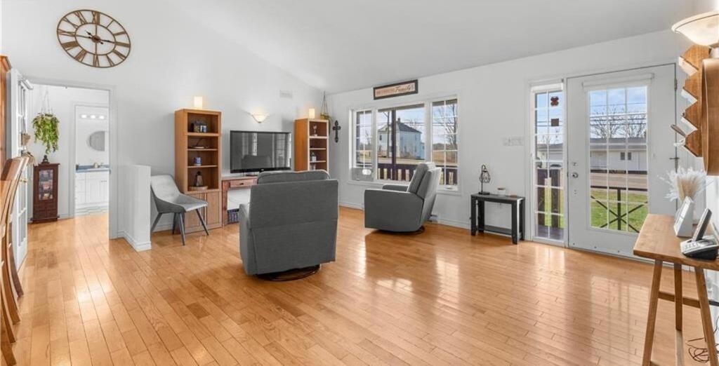 a living room with a table and chairs and a clock at Cue & couch retreat in Dieppe