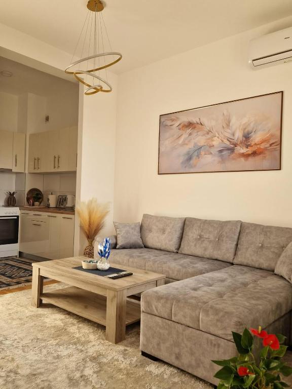 a living room with a couch and a coffee table at Avenue Apartment Sarajevo in Sarajevo