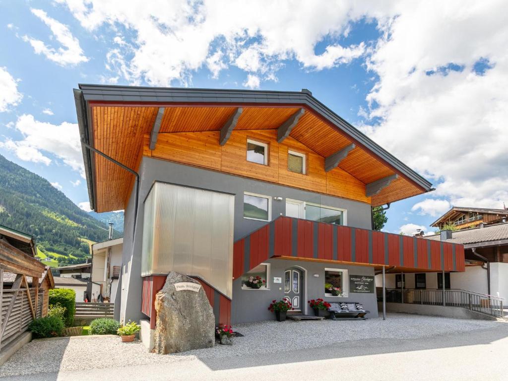 a house with a wooden roof at Alpenlodge Steiger in Neukirchen am Großvenediger