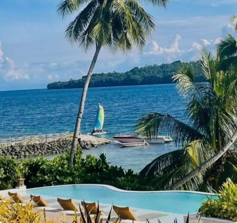 a view of the ocean from a resort with a swimming pool at The Coastal Luxe Suite in Samal