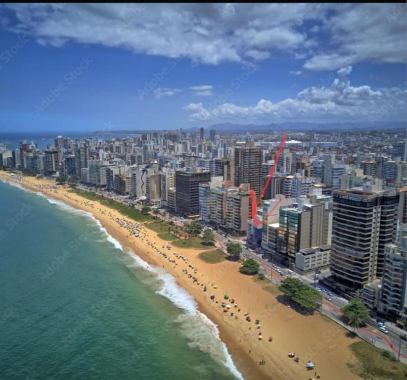 an aerial view of a beach with buildings and the ocean at Flat Praia da Costa in Vila Velha