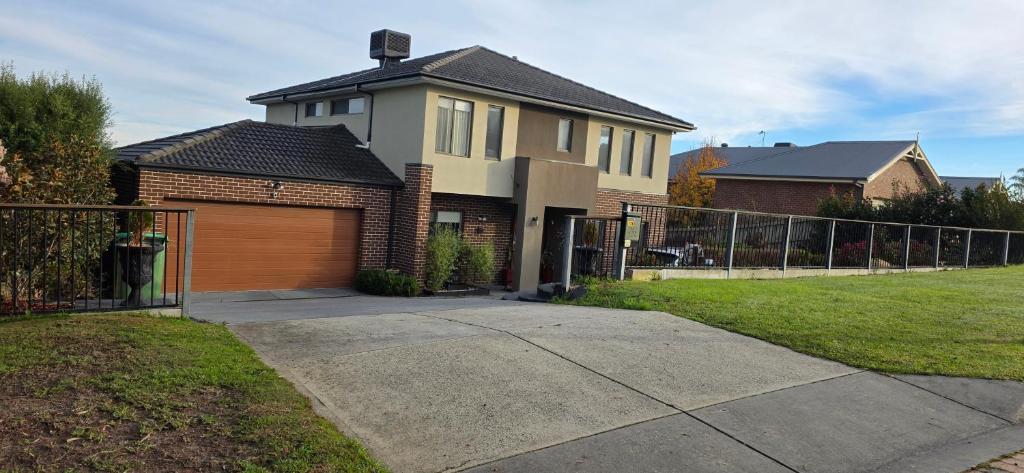 a house with a garage and a fence at Sunset in Pakenham in Pakenham