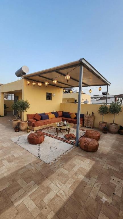 a patio with a couch and a pavilion at VibeLine Surf Camp in Tamraght Ouzdar