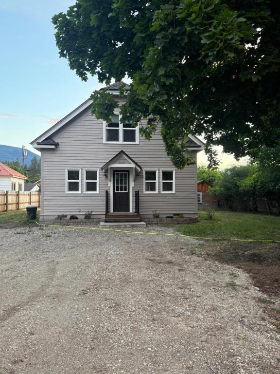 a house with a gravel driveway in front of it at Home Town Mountain Lodging 2 in Darby
