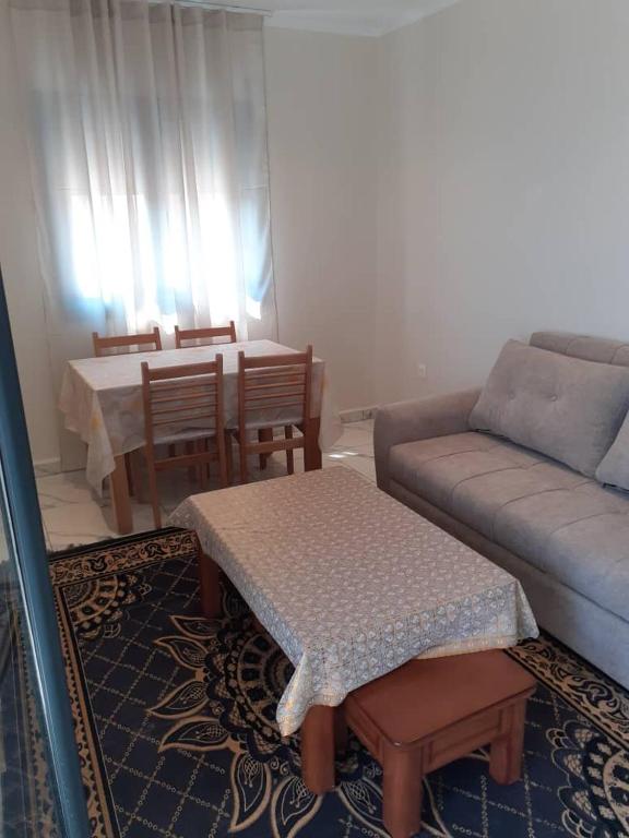 a living room with a couch and a table at Le gîte in Tefeschoun
