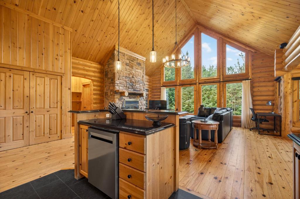 a kitchen with a stove top oven in a cabin at Fiddler Lake Resort - Rabbit 57 in Mille-Isles