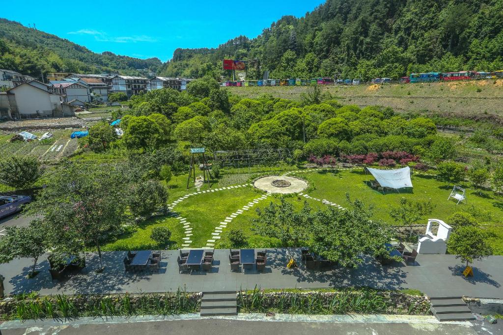 an overhead view of a park with chairs and trees at Pure House--Free shuttle Service to South Gate of the Forest Park,Attraction Tickets Serivce in advance, Mount View, Nature village and Tranguility in Zhangjiajie