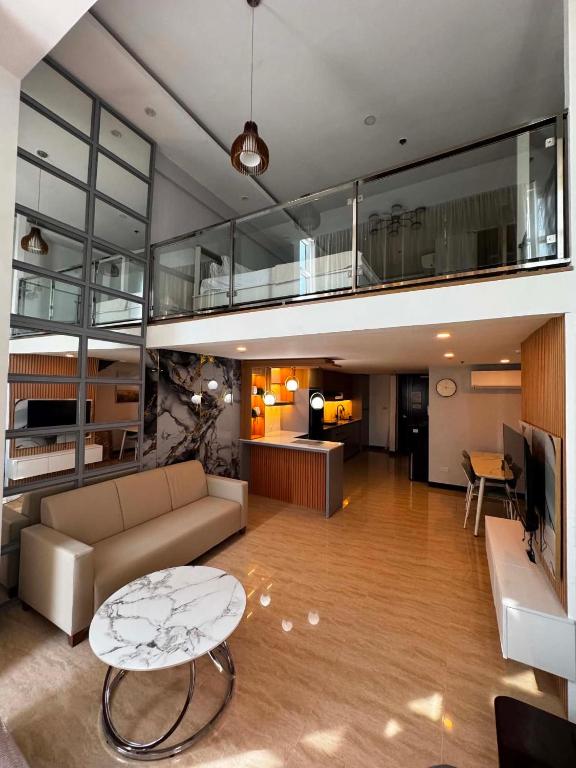 a living room with a couch and a table at Luxury Loft at Crown Regency in Cebu City