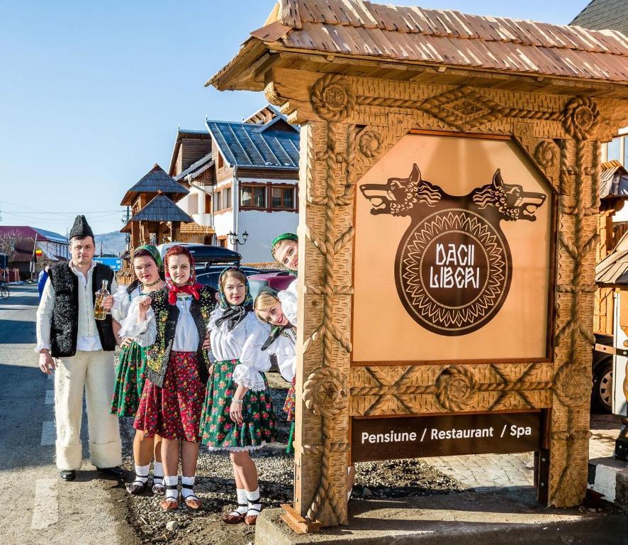 a group of people standing in front of a sign at Dacii Liberi Resort and Spa in Petrova