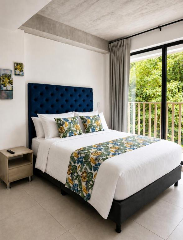 a bedroom with a large bed and a window at Apartamento Armenia in Armenia