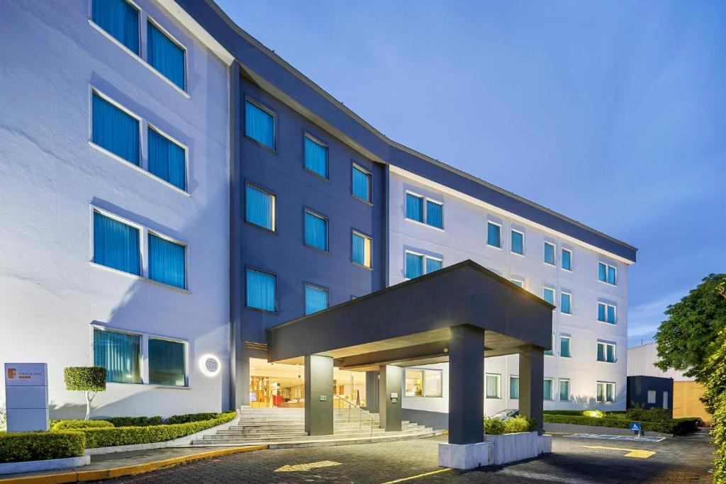 a large white building with a entrance at Fiesta Inn Express Perinorte in Mexico City