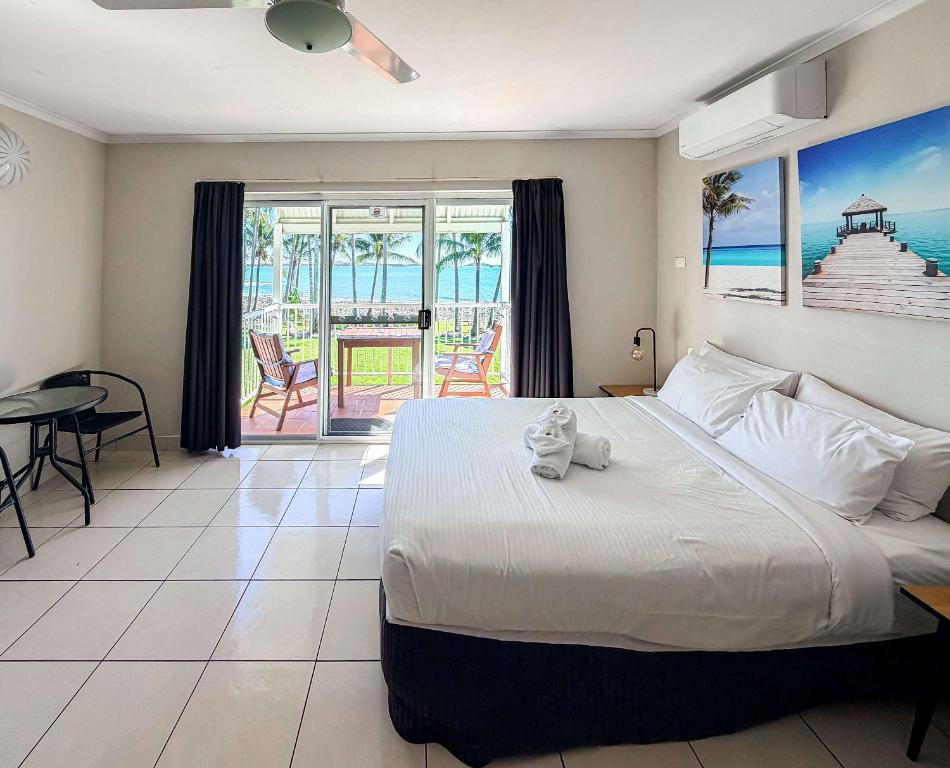 a bedroom with a bed and a view of the ocean at U240 Dhr in Eimeo
