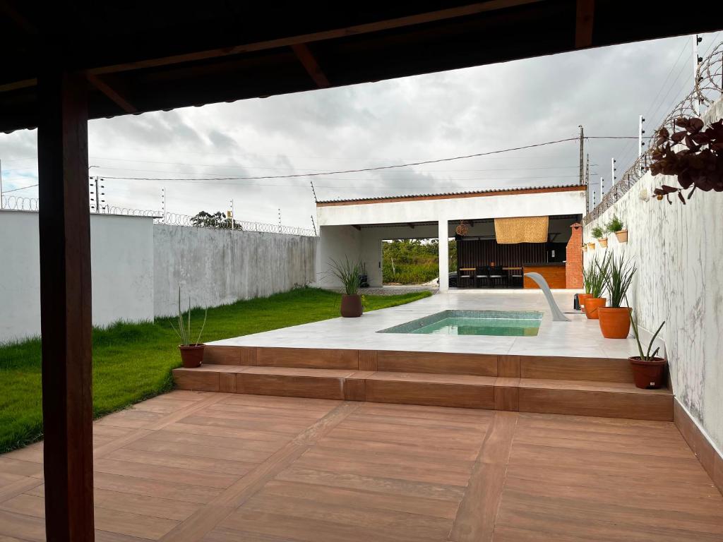 a patio with a swimming pool in a backyard at Casa da Brisa in Salinópolis