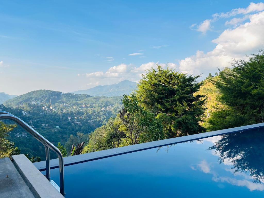 a swimming pool with a view of the mountains at Cozy Resort Ella in Ella