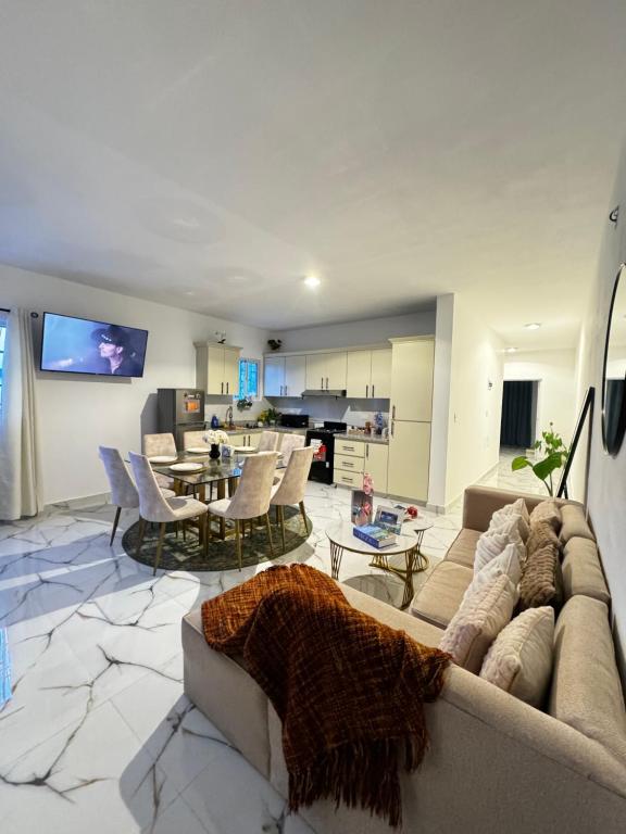 a living room with a couch and a table at Apartamentos SCARLEM in Higuey