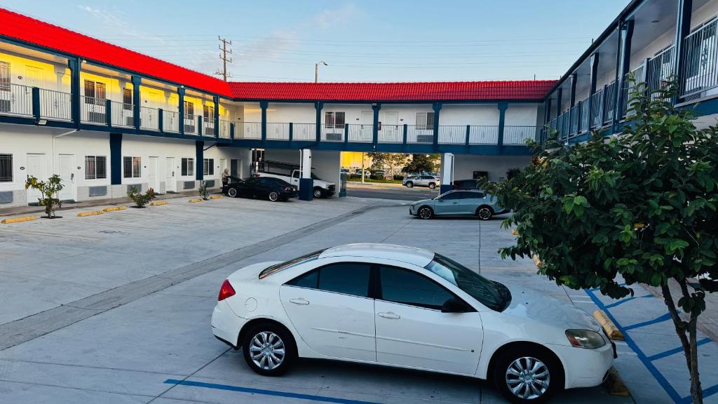 a white car parked in front of a building at Dream Inn in Inglewood