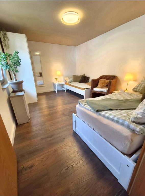 a room with a bed and a couch in a room at Wohnung beim Kodderey ruhig und herzlich in Neuhof