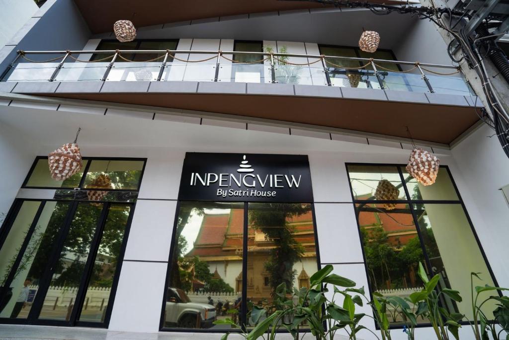 a building with a sign for the entrance to an apartment at Inpeng View Hotel in Vientiane