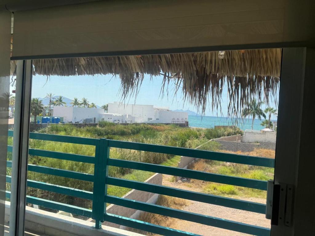 a view of the ocean from a window at DEPARTAMENTO SOL Y MAR in San Carlos