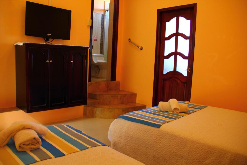 Postel nebo postele na pokoji v ubytování Hostal Duncan