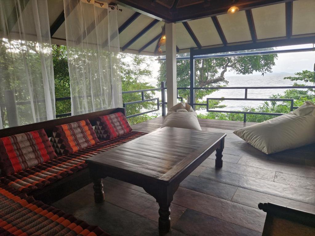 a living room with a couch and a table at Jasmin Garden Koh Kood in Ko Kood