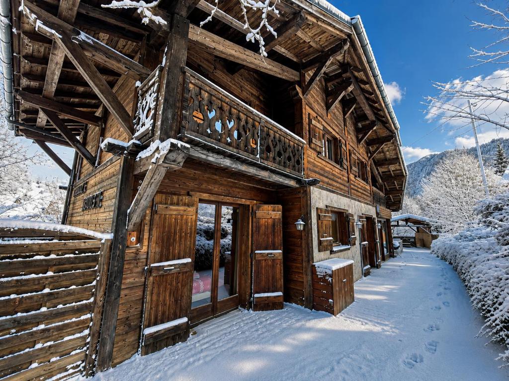 a log cabin in the snow with snow covered at Chalet Adonis - Montriond, Morzine, Avoriaz in Montriond