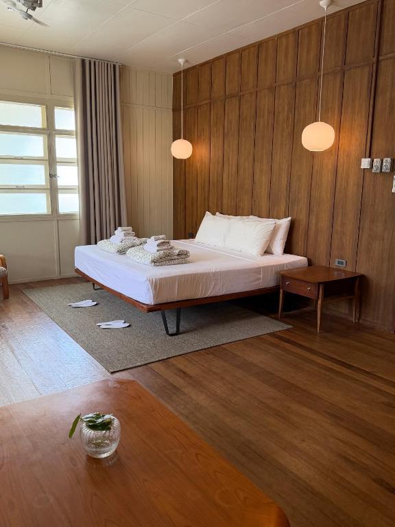 a bedroom with a bed and a wooden wall at The Lewis House in San Juan