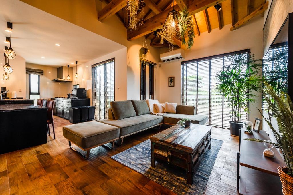 a living room with a couch and a table at The Villa Miyako in Hirara