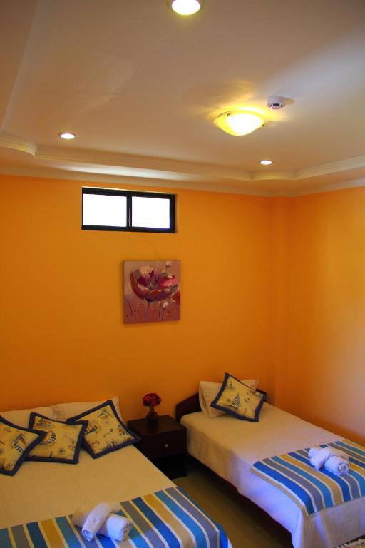 Postel nebo postele na pokoji v ubytování Hostal Duncan