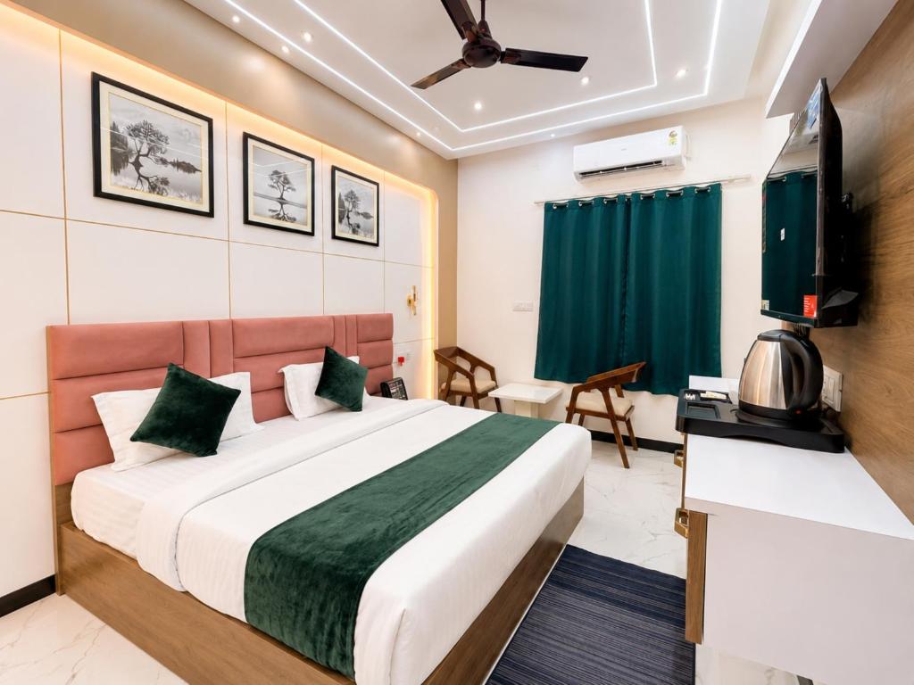 a hotel room with a bed and a flat screen tv at Hotel Royal Awadh Near Shree Ram Mandir Ayodhya in Ayodhya