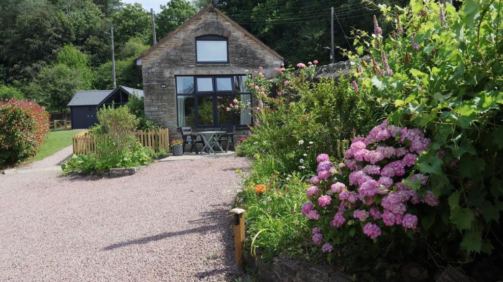 a house with a bunch of flowers in front of it at Horse Gin in Lydney