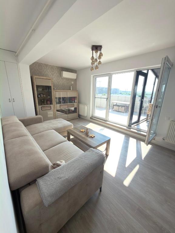 a living room with a couch and a table at Cajara Home in Bucharest