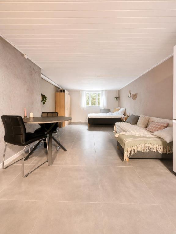 a living room with a couch and a table at Quiet and charming studio apartment in Vejle