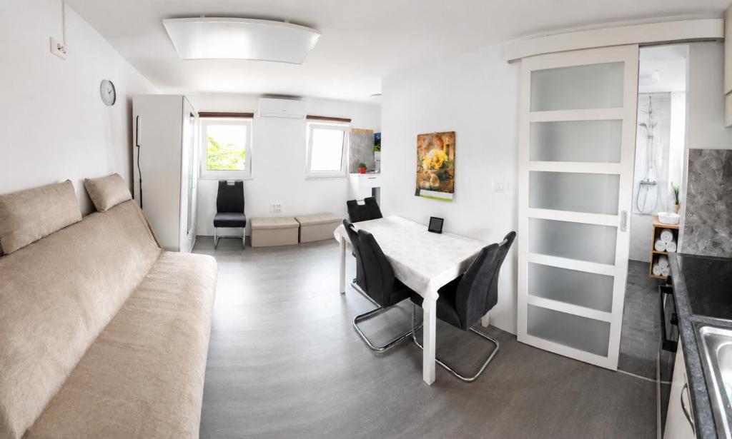 a living room with a couch and a table at Apartma Sonček in Šentjur