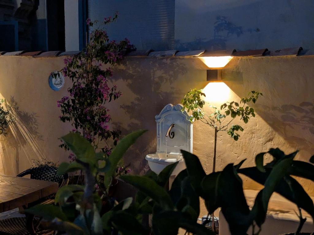 a bathroom with a sink and a light on the wall at Dieu Bé Nice in Nice