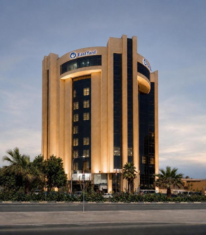 a large building with a sign on top of it at Eastyard Khobar Hotel in Al Khobar