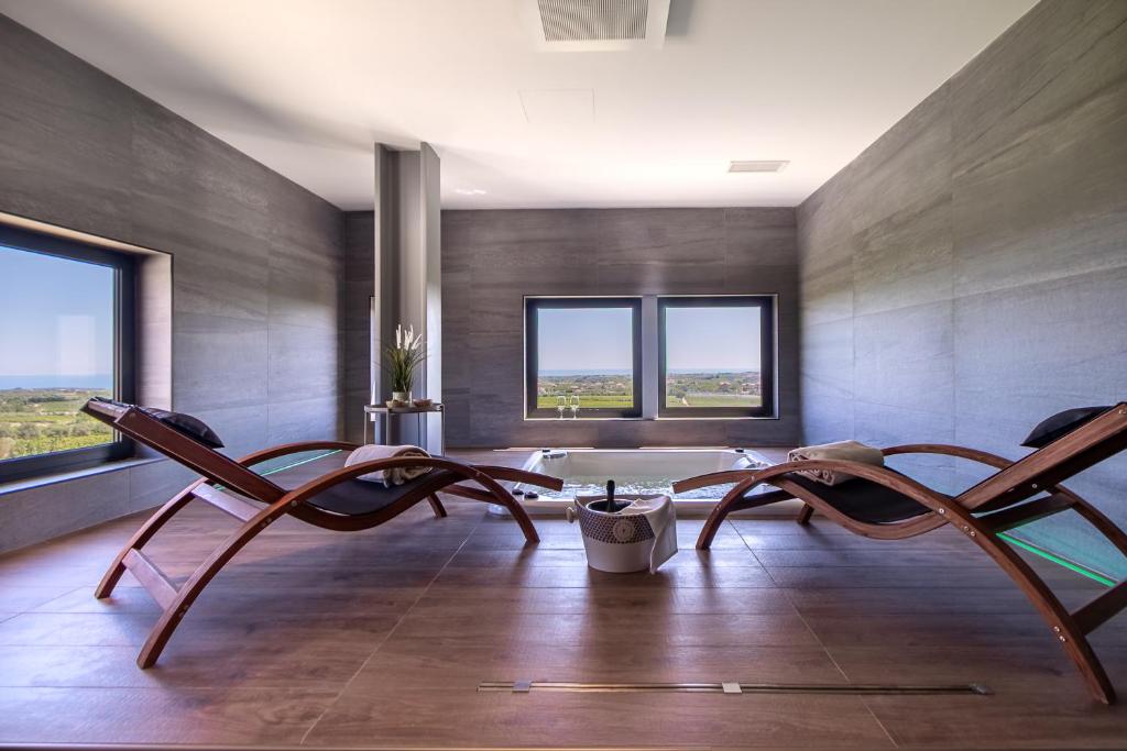 a living room with two chairs and a table at Feudo Antico in Tollo