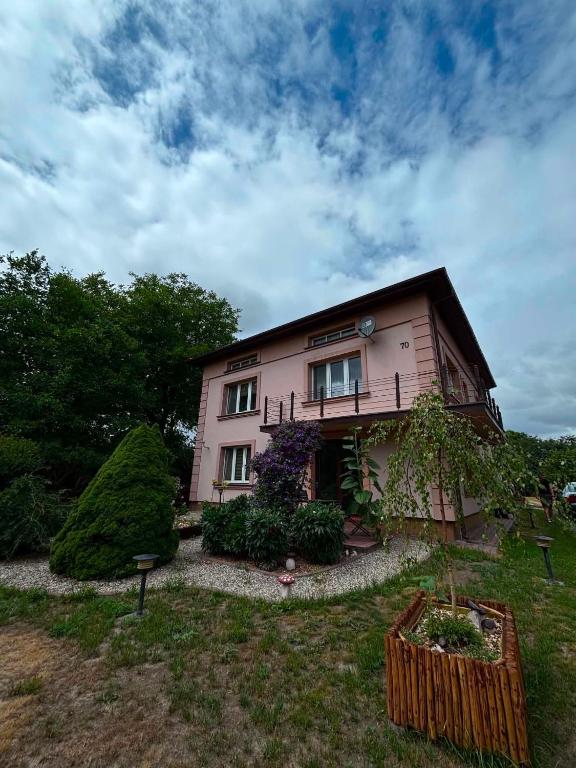 a house with a garden in front of it at Wypoczynek pod leszczynami in Sitno