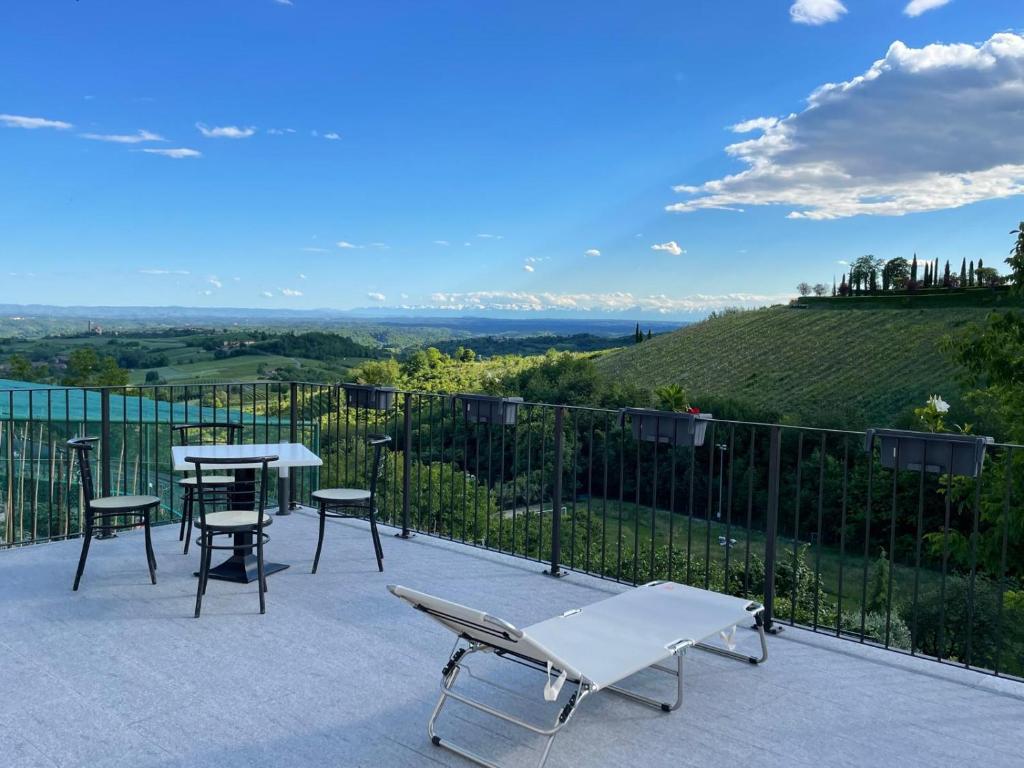 a patio with a table and chairs and a view at Bed and Breakfast Casa Tortia in Cocconato