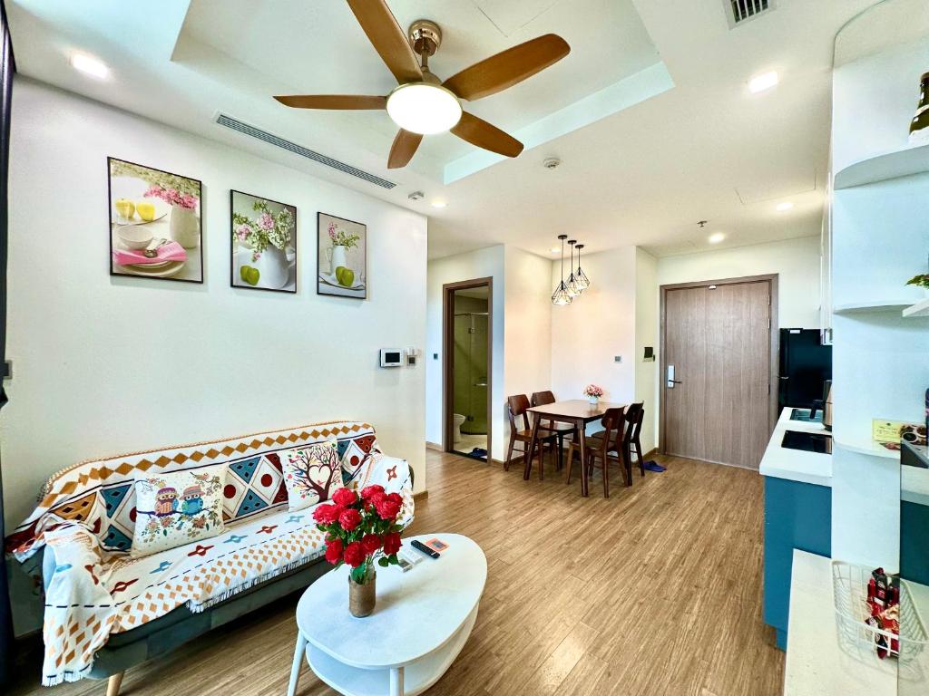 a living room with a couch and a table at Cozy Skyline Escape 2Bedroom Near Hanoi Major Business District in Hanoi