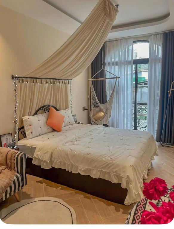 a bedroom with a bed with a hammock in it at Homestay Beauty D1 in Ho Chi Minh City