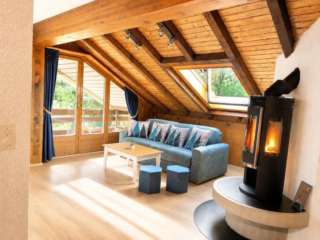 a living room with a couch and a fireplace at Ovronnaz , 2 pièces appartement Marana in Ovronnaz