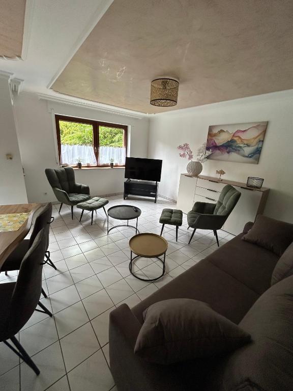 a living room with a couch and chairs and a piano at Apartment Grenzland in Herzogenrath