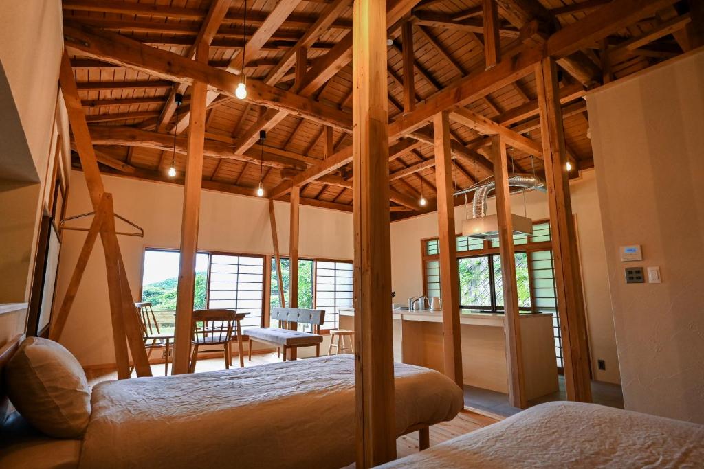 a bedroom with two beds and a dining room at Beppu TOJIHAUS 002 Hilltop Sea View 8min walk to Hells of Beppu in Beppu