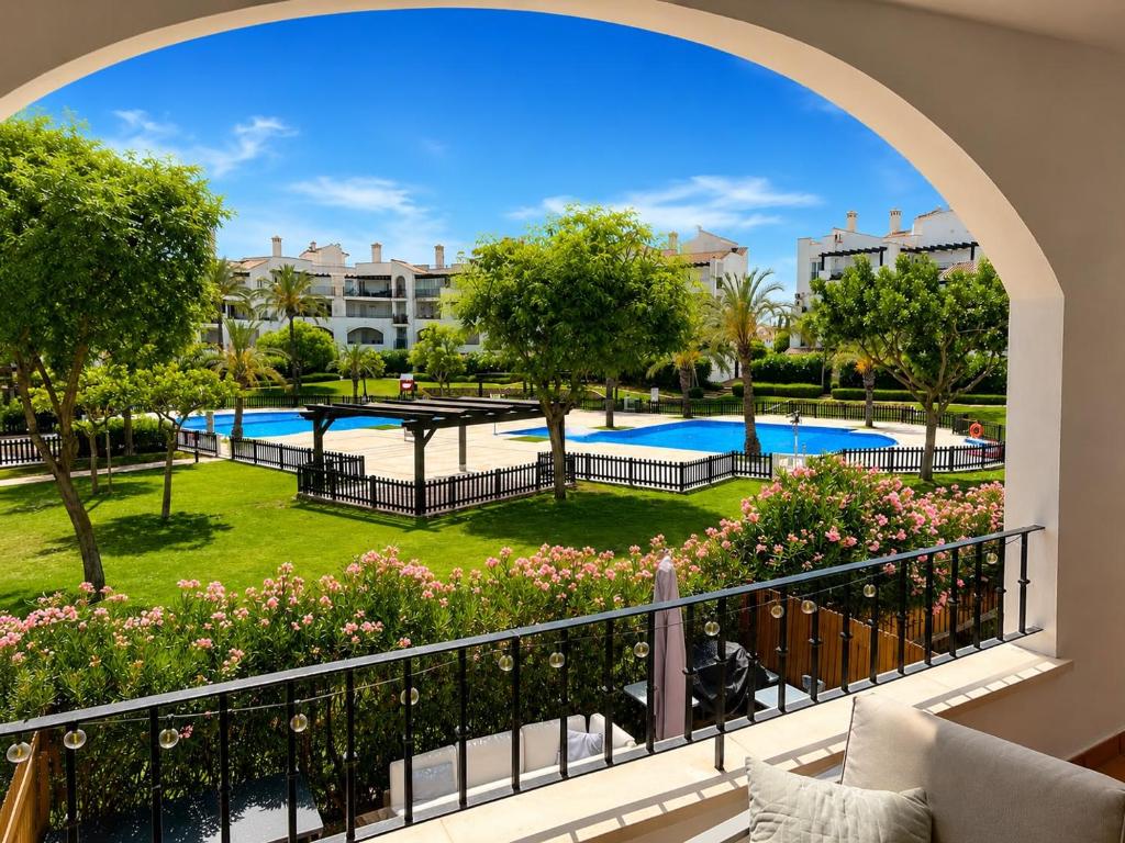 a view of the pool from the balcony of a apartment at Casa Lilo - Renovated 2-Bed Apartment with Pool View - La Torre Golf Resort in Torre-Pacheco