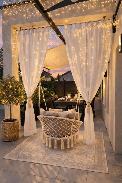 a patio with a hammock and string lights at L'escapade étoilés in Andancette