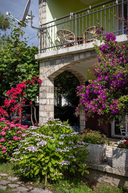 a balcony on a house with pink flowers at Boka Garden in Bijela