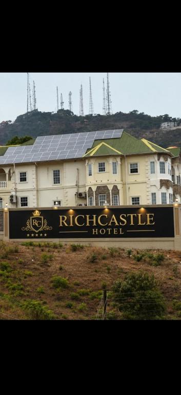 a house with a sign in front of it at Richcastle Hotel in Freetown